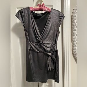 Woman’s sleeveless top. Stretchy. Shiny.